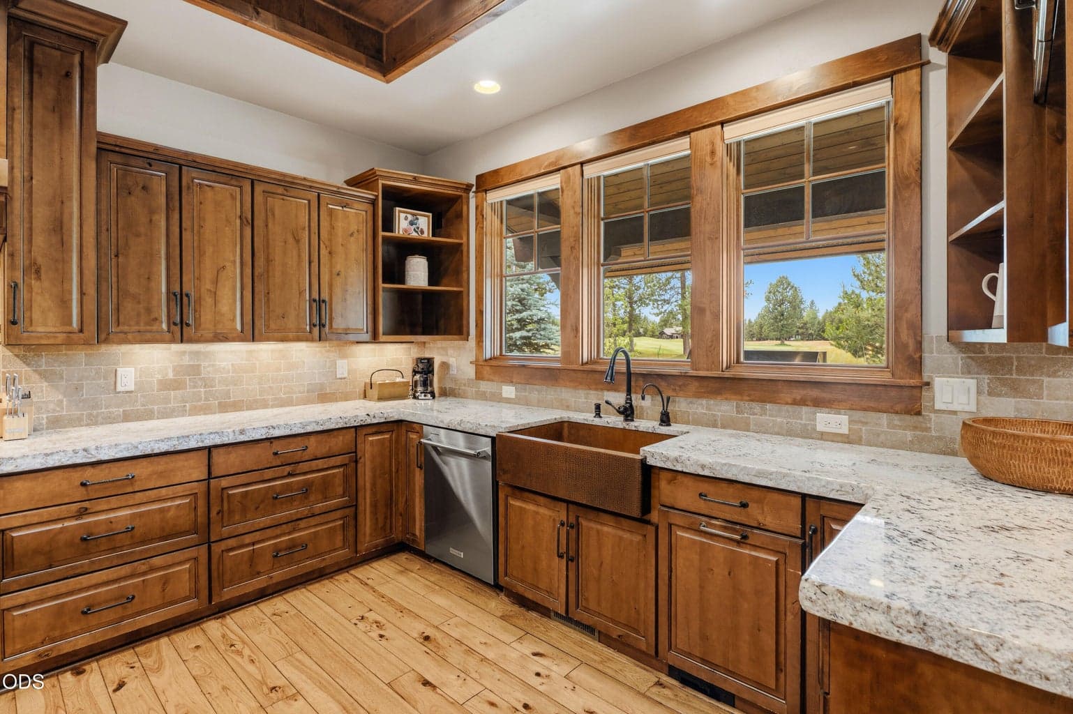 Enjoy preparing meals while taking in peaceful golf course views from the copper farmhouse sink and oversized picture windows.