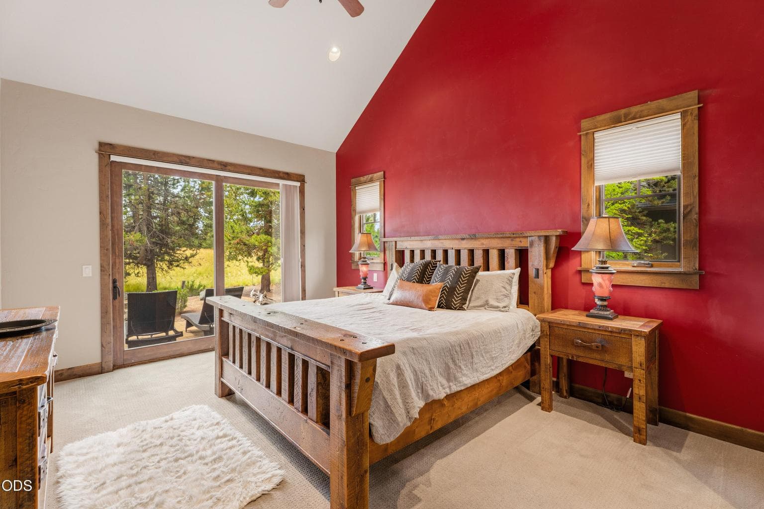 The spacious main-level primary suite offers private patio access and peaceful views.