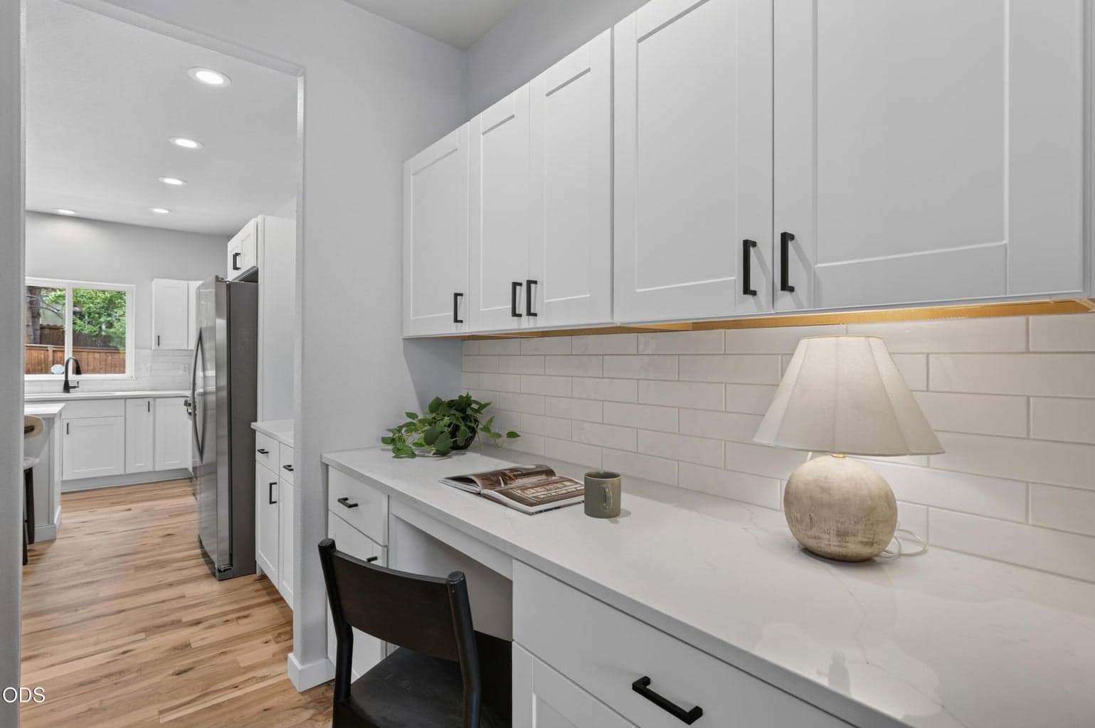Butler's pantry desk / cabinetry and view to kitchen