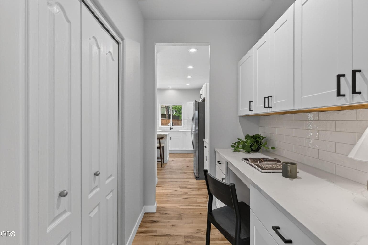 Butler's pantry storage / desk and view to kitchen