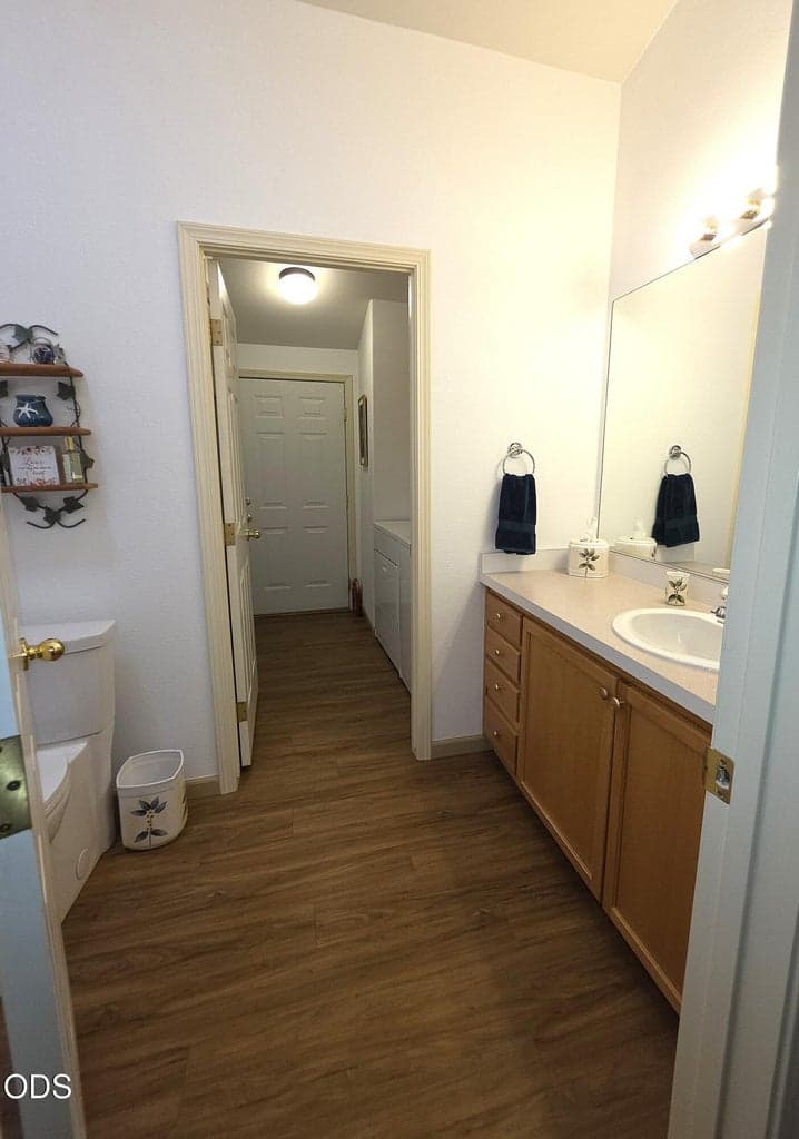 Pass from hallway through guest bathroom to access laundry room and door to garage