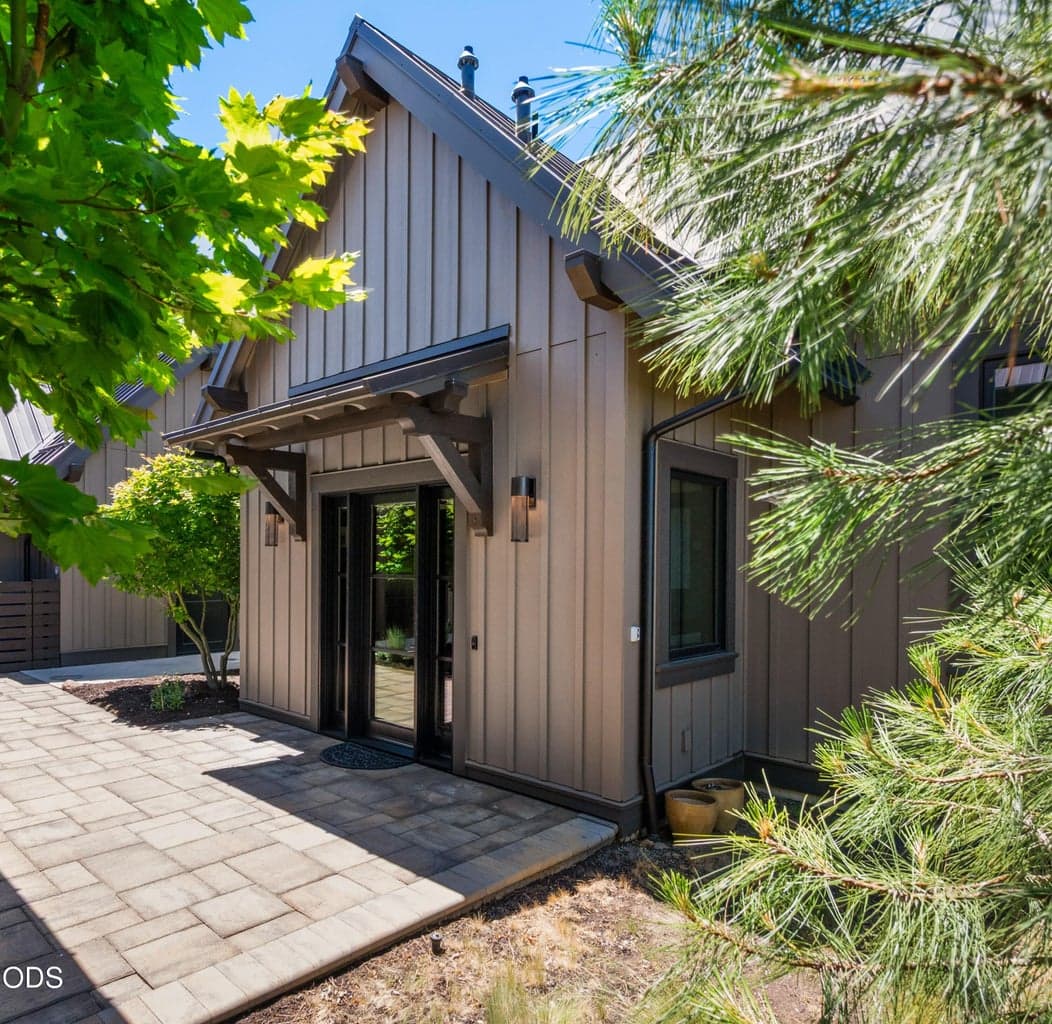 Oversized one-car garage with owners' lockoff storage has one shared wall. Home is freestanding.