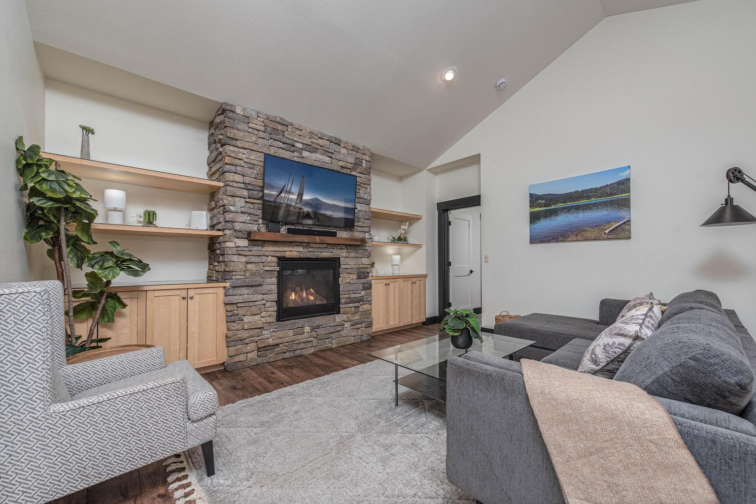 Beautiful stone fireplace with custom built in's on either side. The fireplace provides warmth and ambience with the flip of a switch.