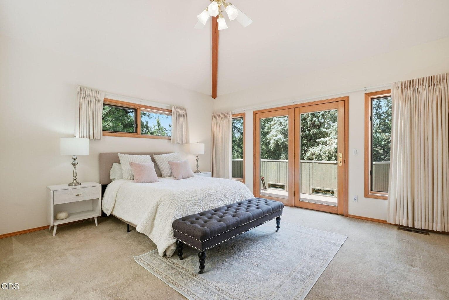 Primary bedroom with vaulted ceiling