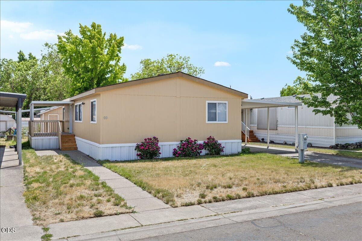 Front with side entrance and large covered deck