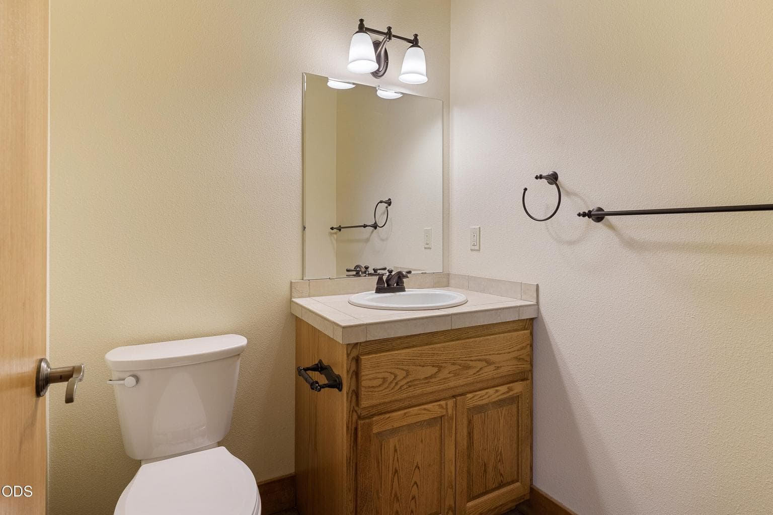 Half bathroom near kitchen and laundry room
