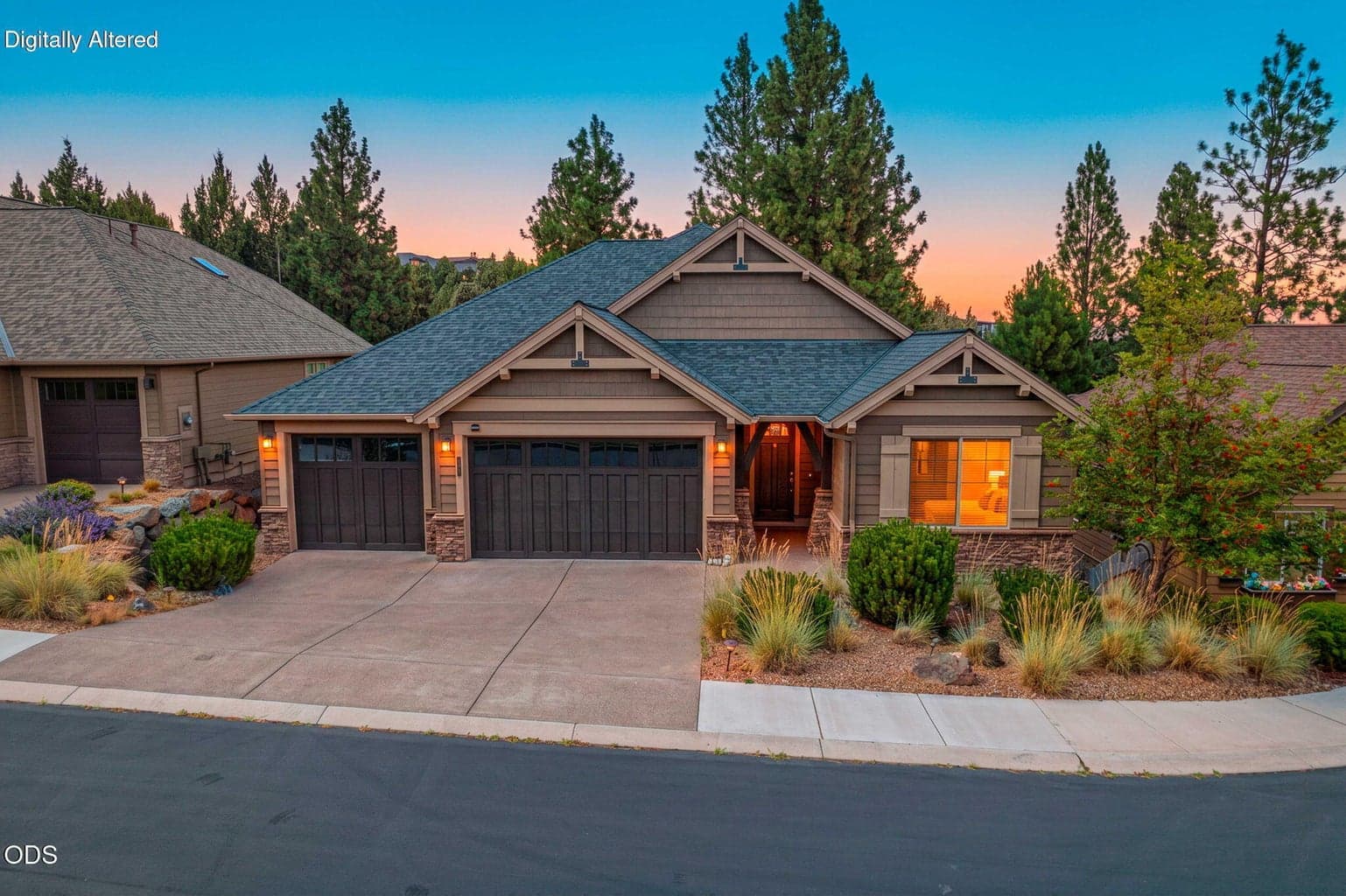 NW Bend home exterior with three-car garage, mature pines, and low-maintenance landscaping.
