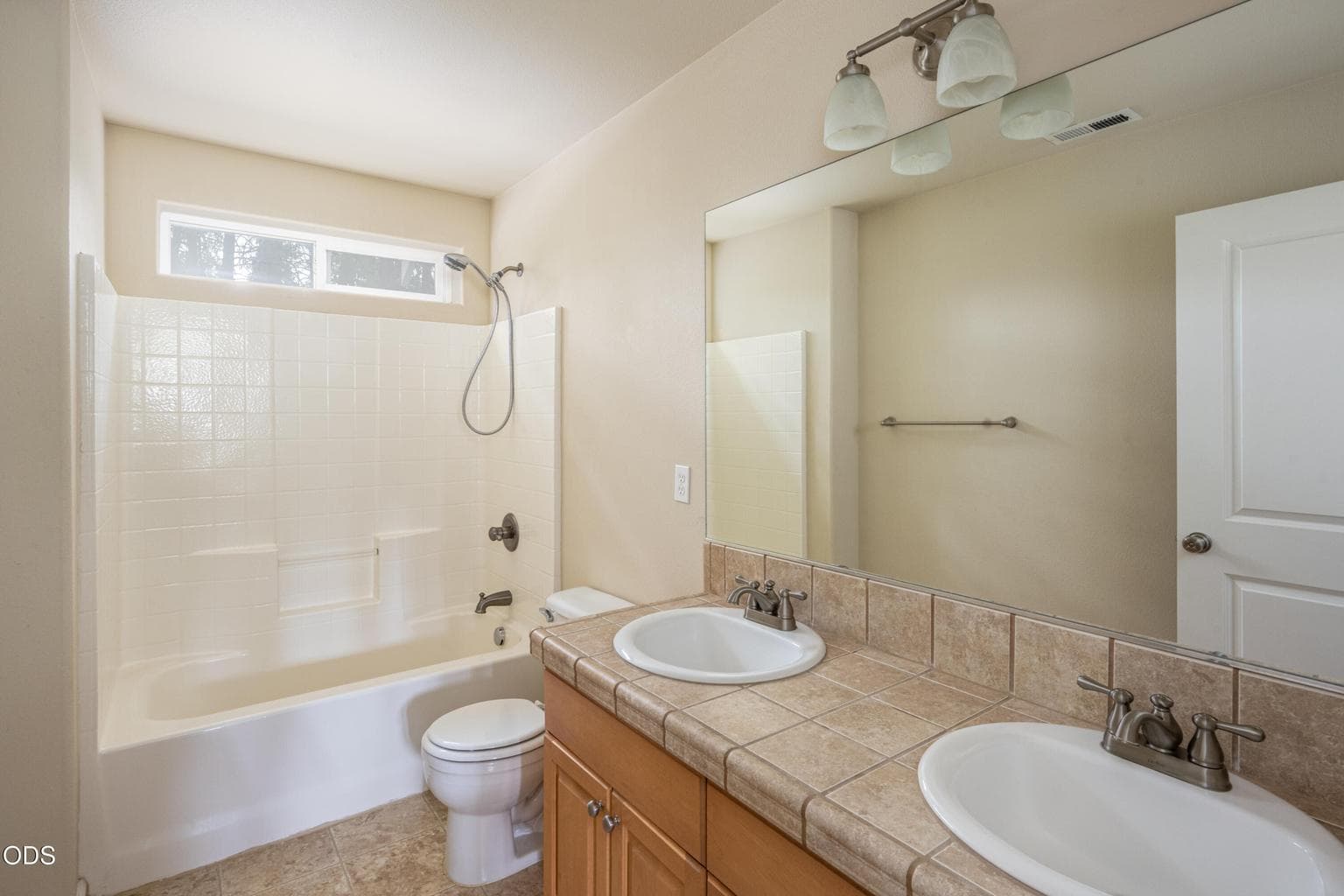 Full bath with dual sinks and plenty of space