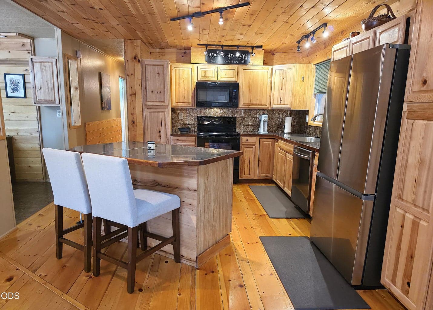 Kitchen has island with breakfast bar