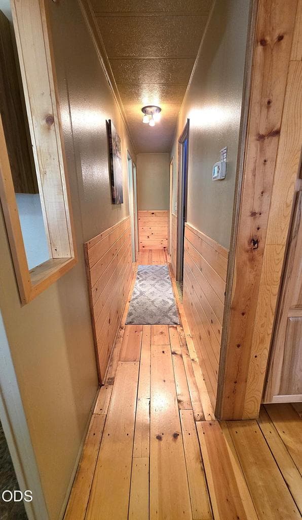 Hallway to secondary bedrooms, guest bath, and laundry room