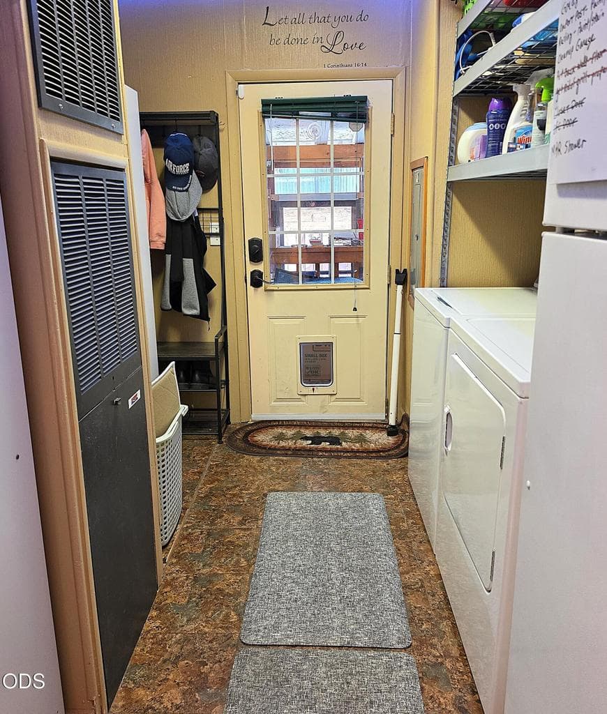 Laundry Room has storage shelves above washer and dryer