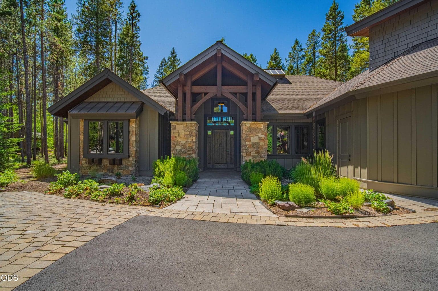 Stone columns, substantial timber details, and a sheltered entry set the tone for a home designed with both presence and warmth, moments from Caldera Springs amenities yet tucked into a naturally private setting.