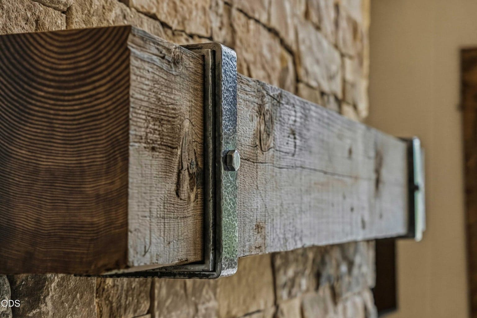 A close view of the wood mantel highlights the tactile craftsmanship and natural textures that give the home its warm High Desert character.
