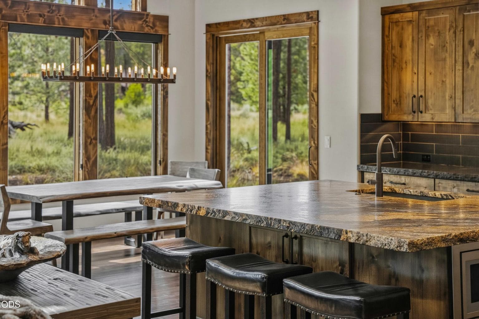 A substantial island, richly grained counters, and a direct connection to the dining area make this kitchen equally suited to quiet mornings and effortless entertaining.