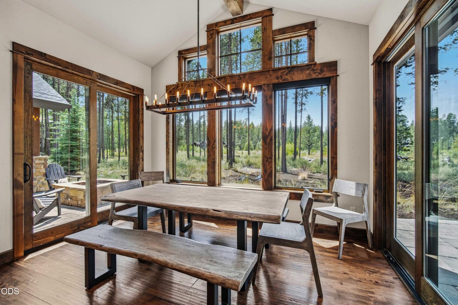 Morning coffee, quiet dinners, or evenings with guests all feel connected to the outdoors here, with tall windows framing mature ponderosa pines and protected open space.