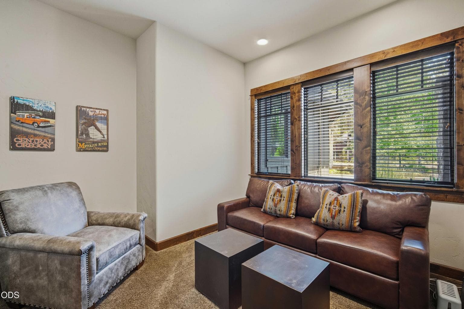 This intimate sitting area provides flexibility for media, reading, work, or overflow guest space while maintaining the home’s warm and refined style.