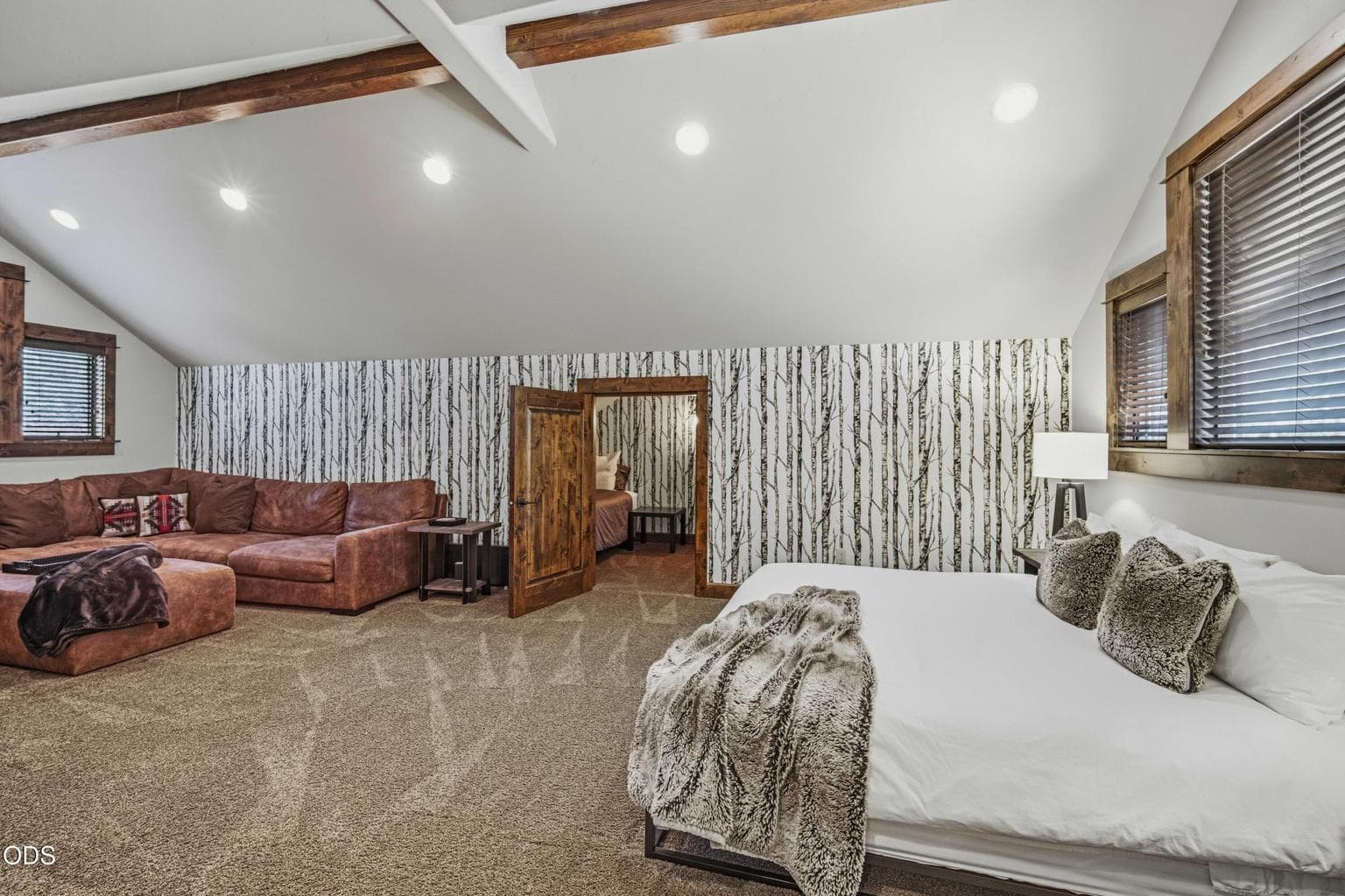 The upstairs bonus room serves as the fourth bedroom, offering generous space for sleeping, lounging, and extended guest stays.