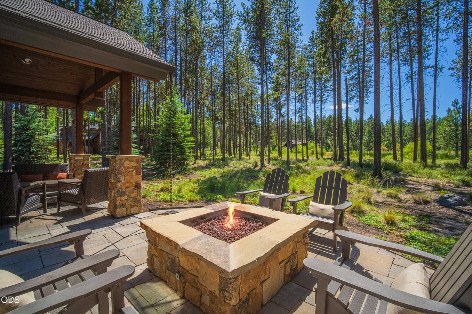 Whether enjoying evenings around the fire beneath the pines or simply taking in the peaceful surroundings, this outdoor gathering area celebrates the home’s extraordinary location.