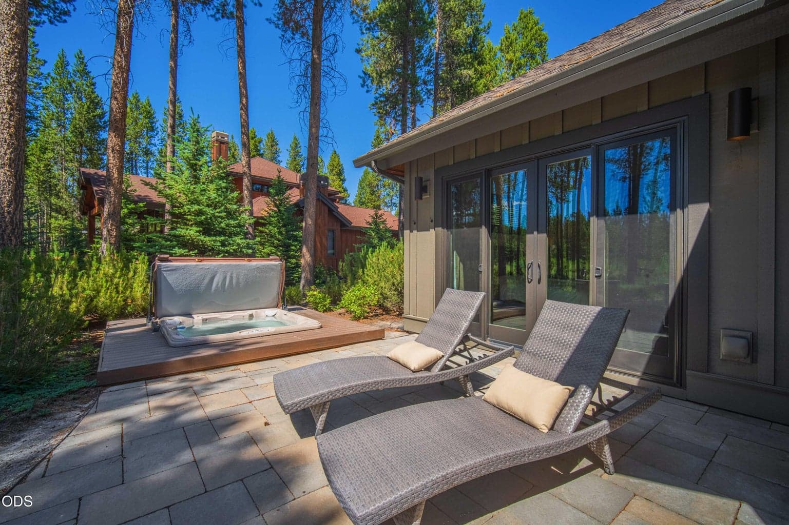 A private hot tub and lounge patio offer year-round enjoyment, surrounded by mature pines and the quiet privacy of this coveted Caldera Springs setting.