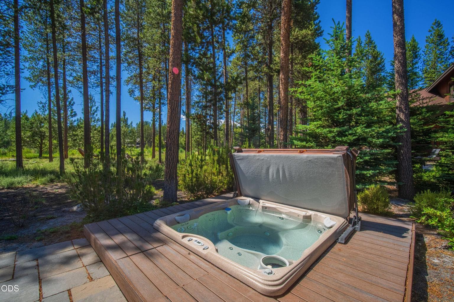 Set among the pines and natural landscaping, the hot tub area feels peaceful and private, a true extension of the home’s Northwest retreat lifestyle.