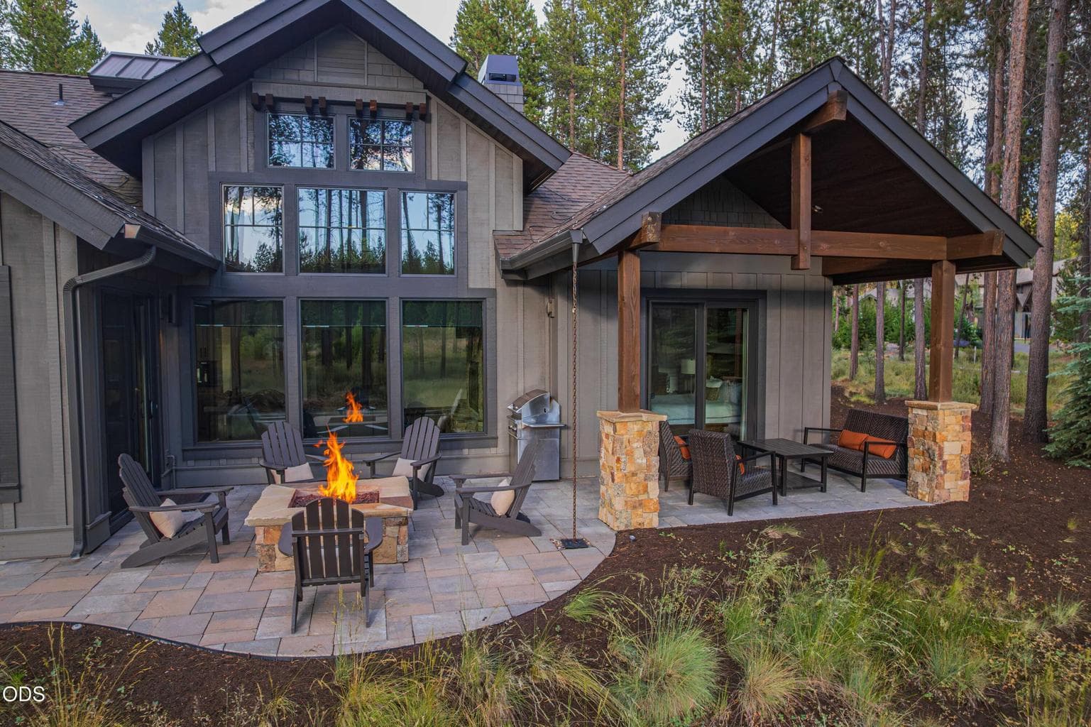 Multiple outdoor gathering areas create year-round opportunities to enjoy the setting, from the covered patio to the fire pit and hot tub.