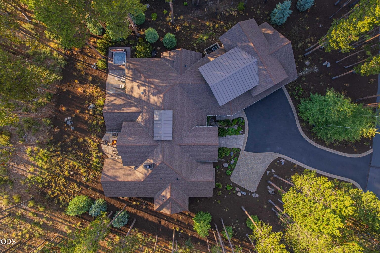 From above, the home’s placement becomes clear: tucked among mature pines, oriented toward outdoor living, and set within one of Caldera Springs’ most naturally beautiful locations.