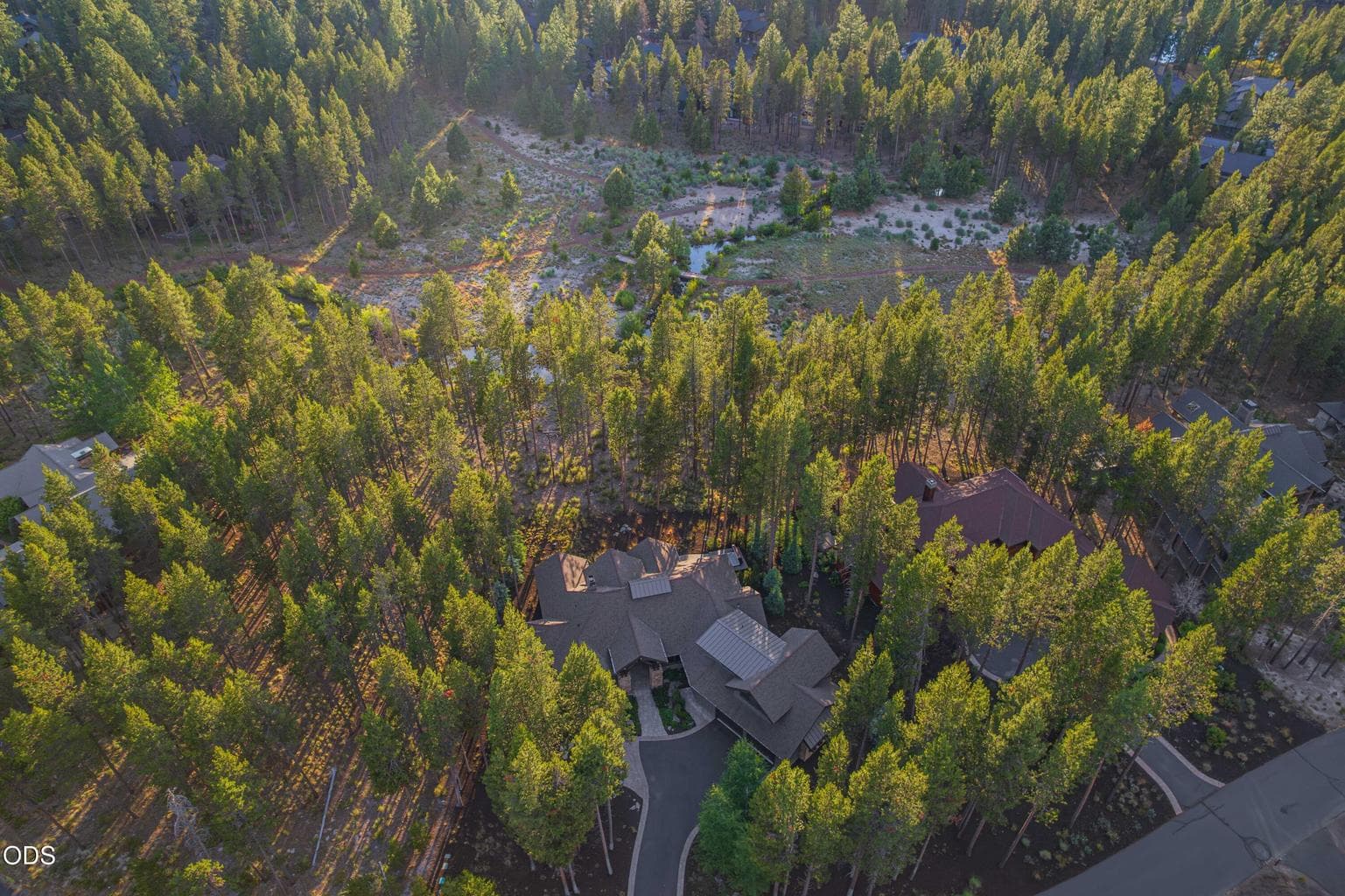 Protected open space, natural water, and mature forest surround the home, underscoring why this setting cannot simply be recreated.