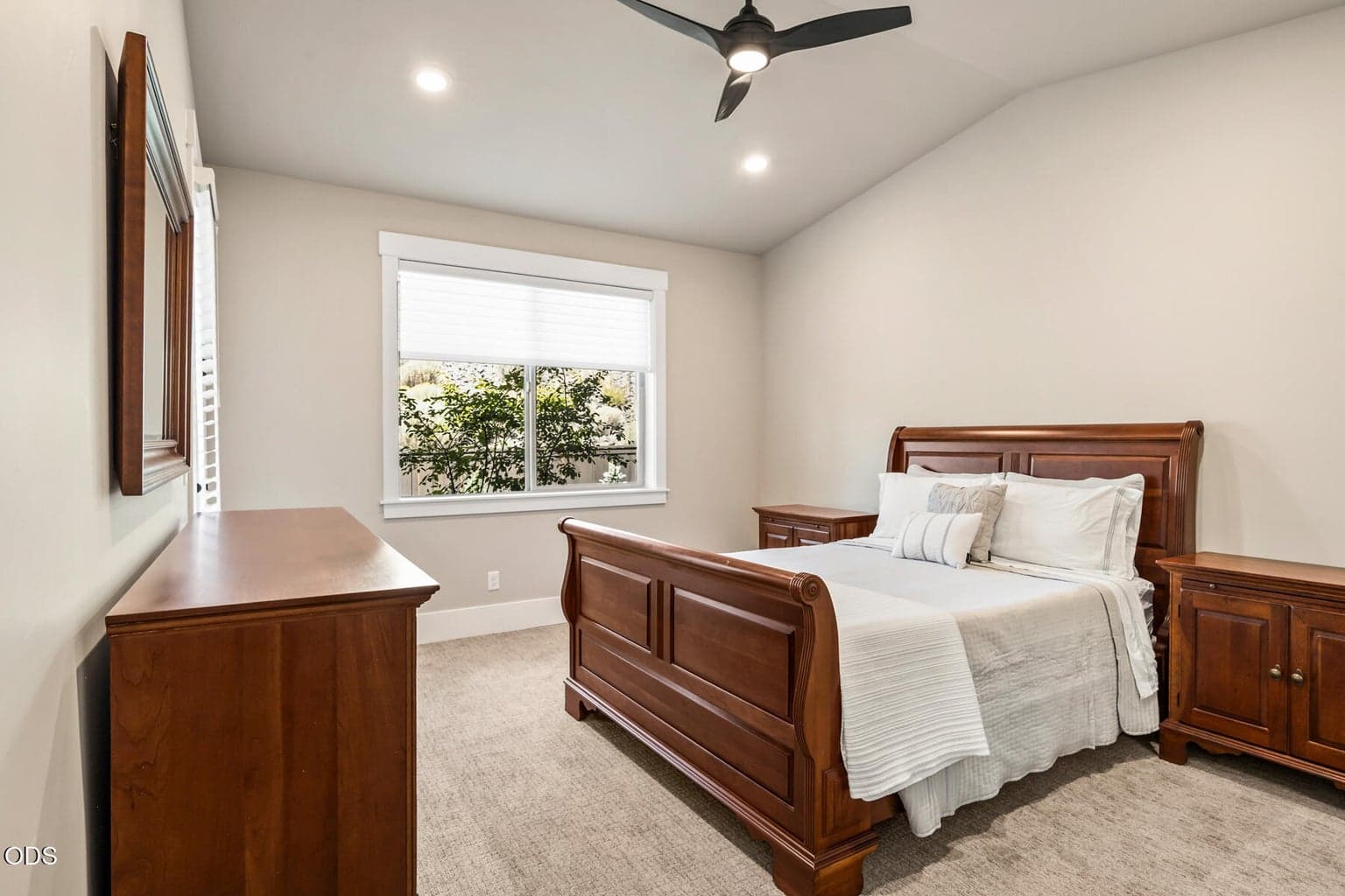 Primary bedroom with vaulted ceilings.