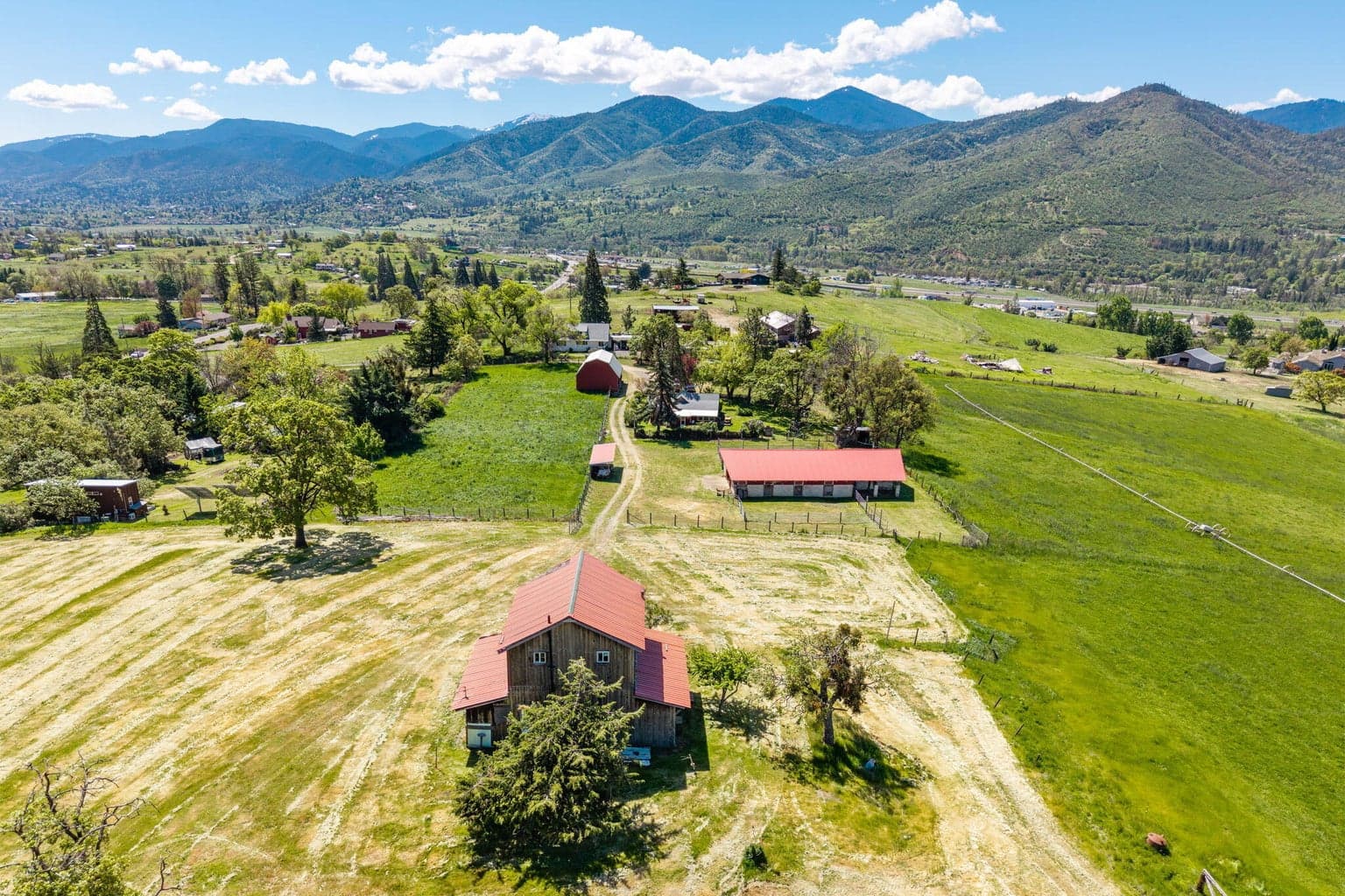 Showing barn, Horse barn, house beyond and irrigated fields.