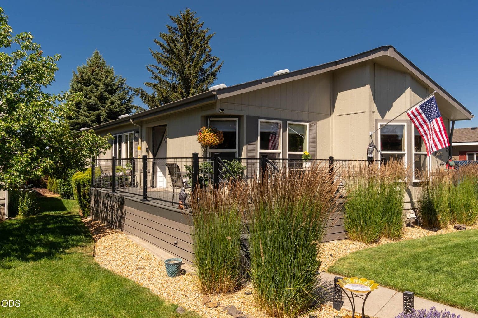 Welcoming fenced-gated entry deck is trex-type easy care material with metal railings.