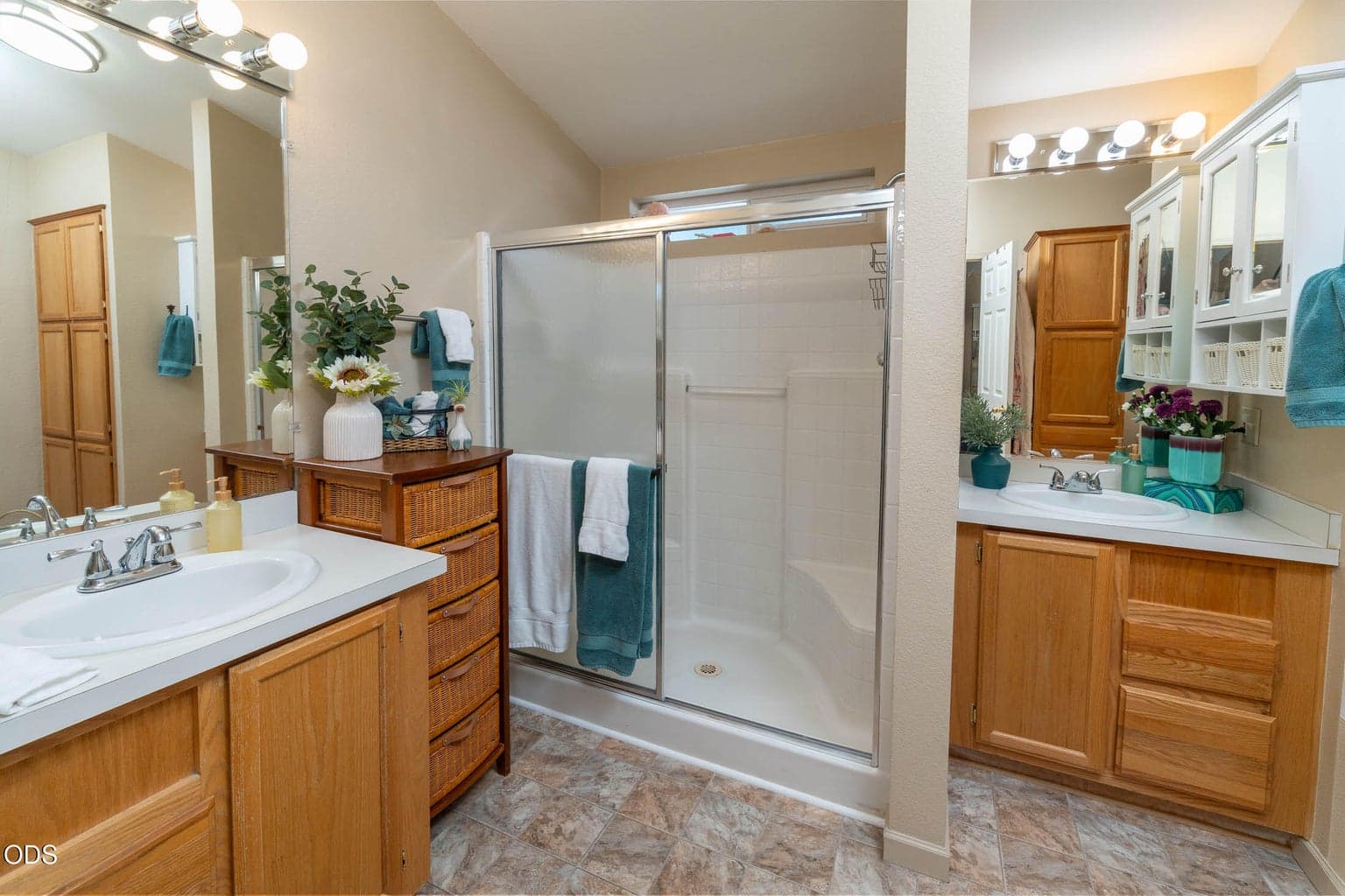 En-suite bath adjoins the primary bedroom. Dual sinks and vanities, large shower, extra storage, very spacious and includes a window.