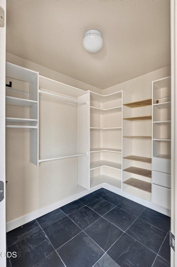 Primary bedroom walk-in closet