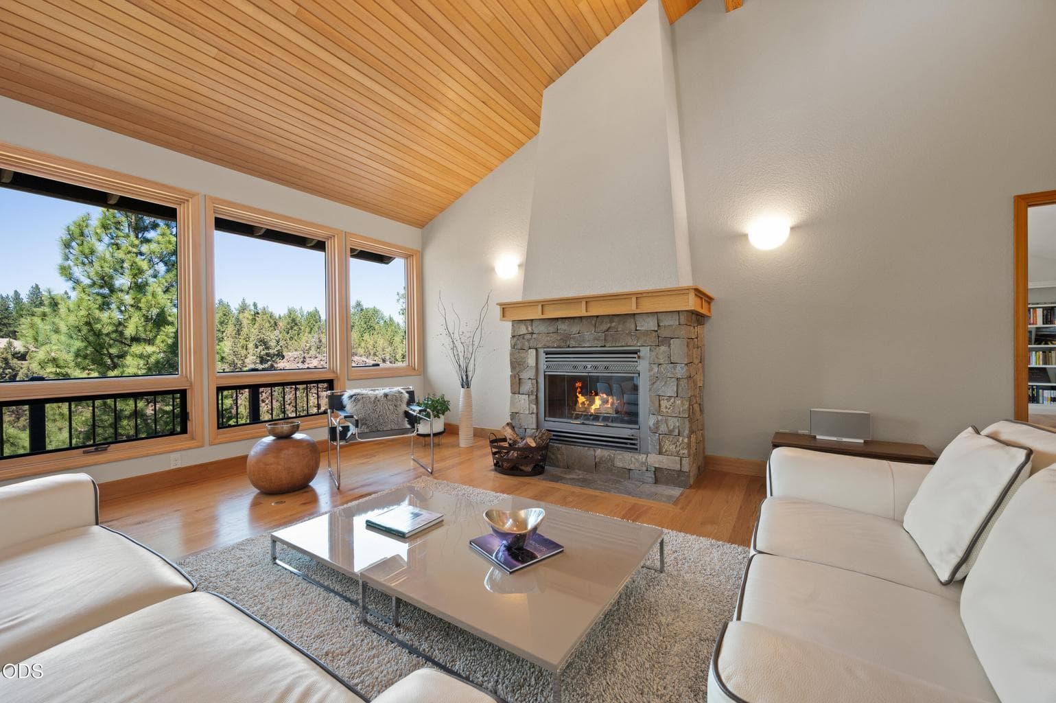 Soaring ceilings and wood burn fireplace with stone surround create the perfect space for entertaining or relaxing.