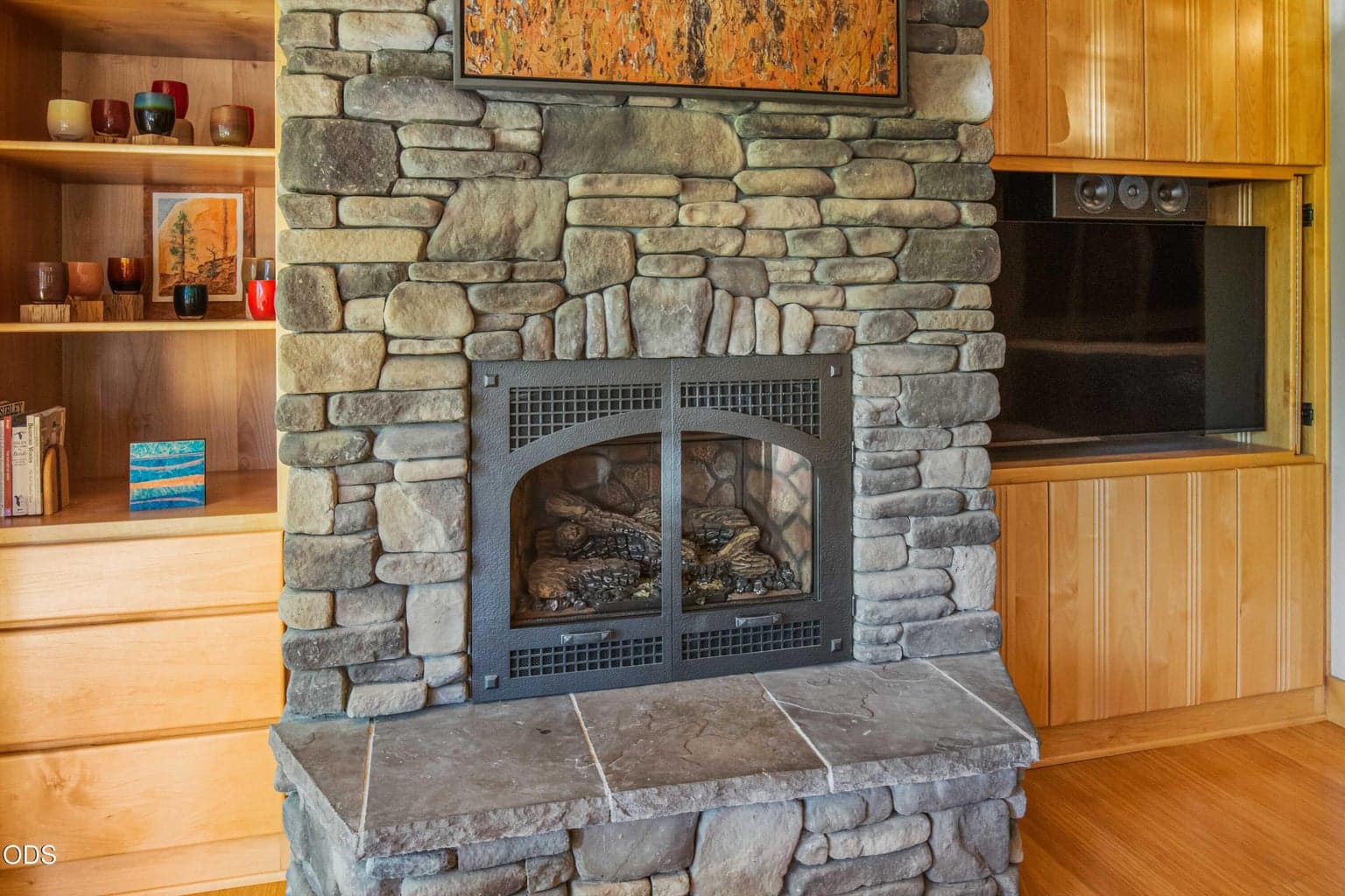 Detailed stonework and a substantial hearth give the great room fireplace a sense of permanence and craftsmanship, reinforcing the natural Central Oregon character of the residence.