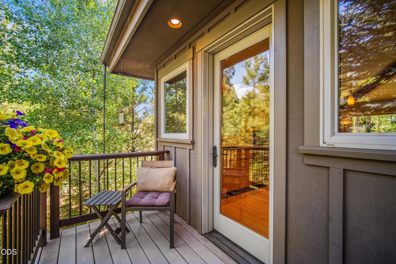 A quiet seating area along the wraparound deck offers an easy outdoor extension of the kitchen.