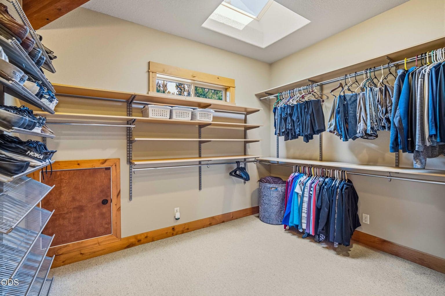 The exceptionally large primary walk-in closet provides extensive hanging space, adjustable shelving, dedicated shoe storage, built-in drawers, natural light and a skylight, offering the scale and organization expected in a substantial full-time residence.