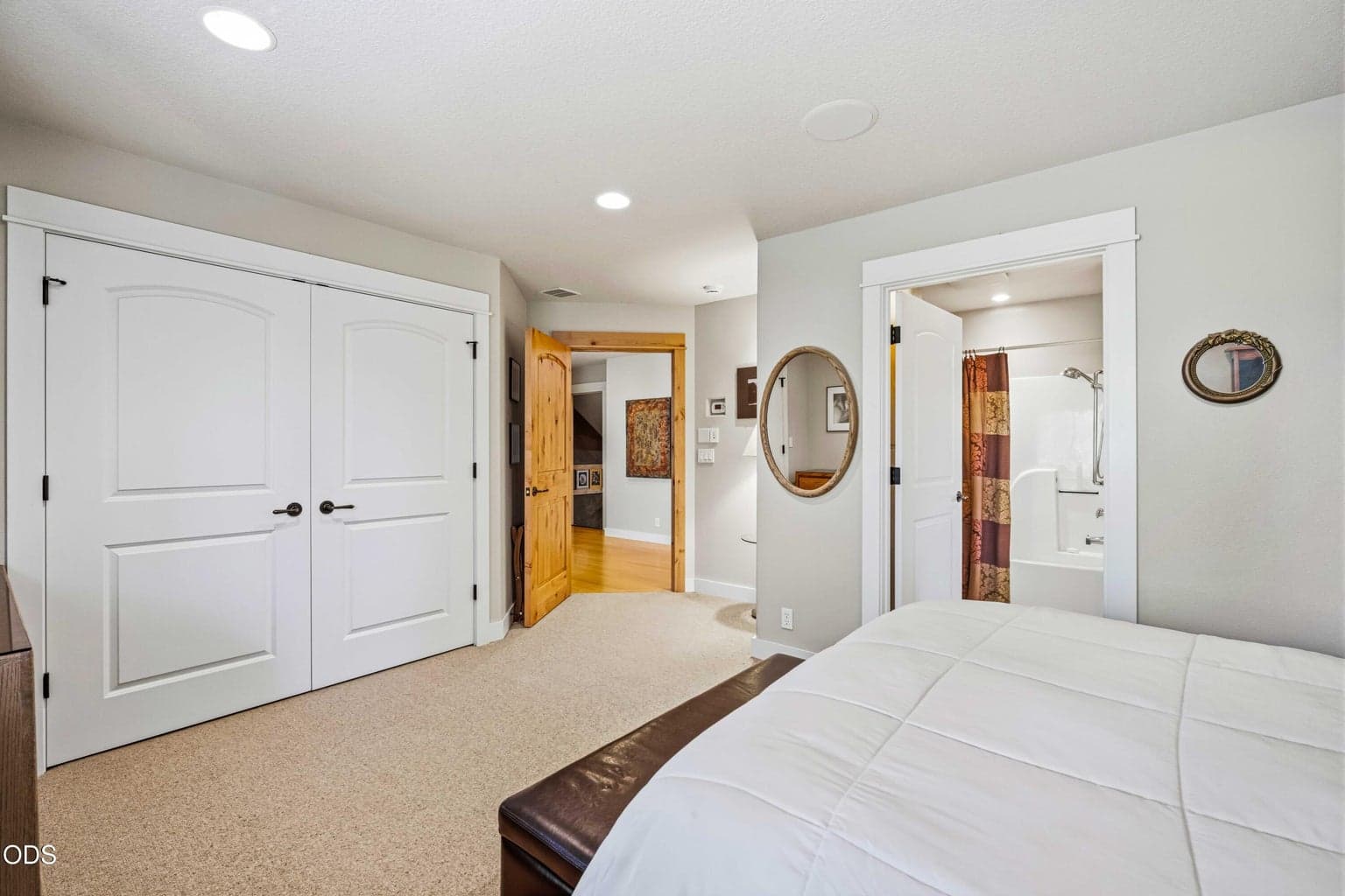 A second view of the lower-level guest suite highlights its generous floor area, extensive closet storage and direct connection to a private ensuite bath. Together with the second downstairs bedroom suite, it provides exceptional privacy and flexibility for guests.