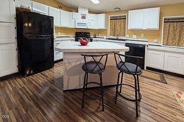Kitchen has island with breakfast bar