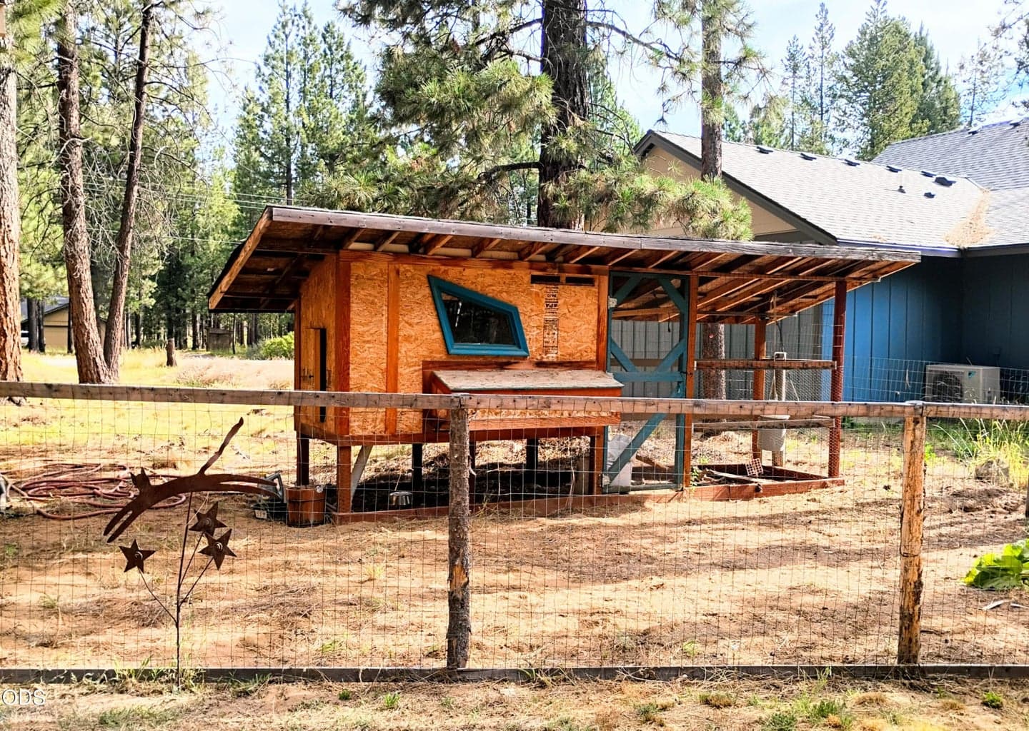 Established chicken coop with fenced outdoor space, perfect for small-scale homesteading or backyard poultry.