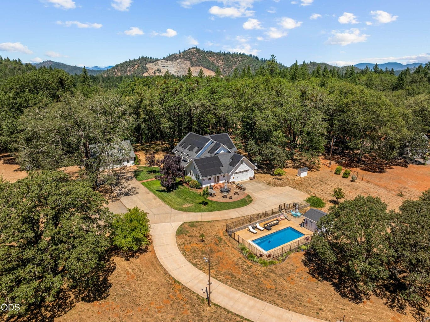 4.26 acres. In ground salt water pool, Solar powered home. Add'l detached garage/shop/guest quarters
