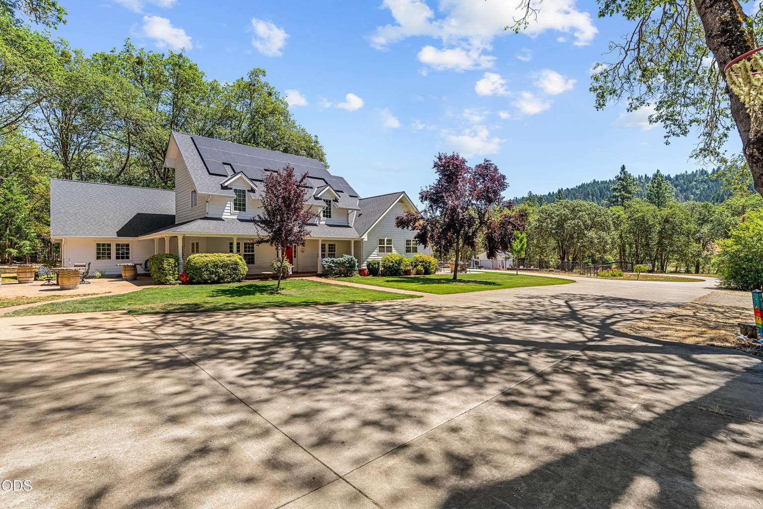 Driveway lead to attached garage and additional detached garage/shop/guest house.