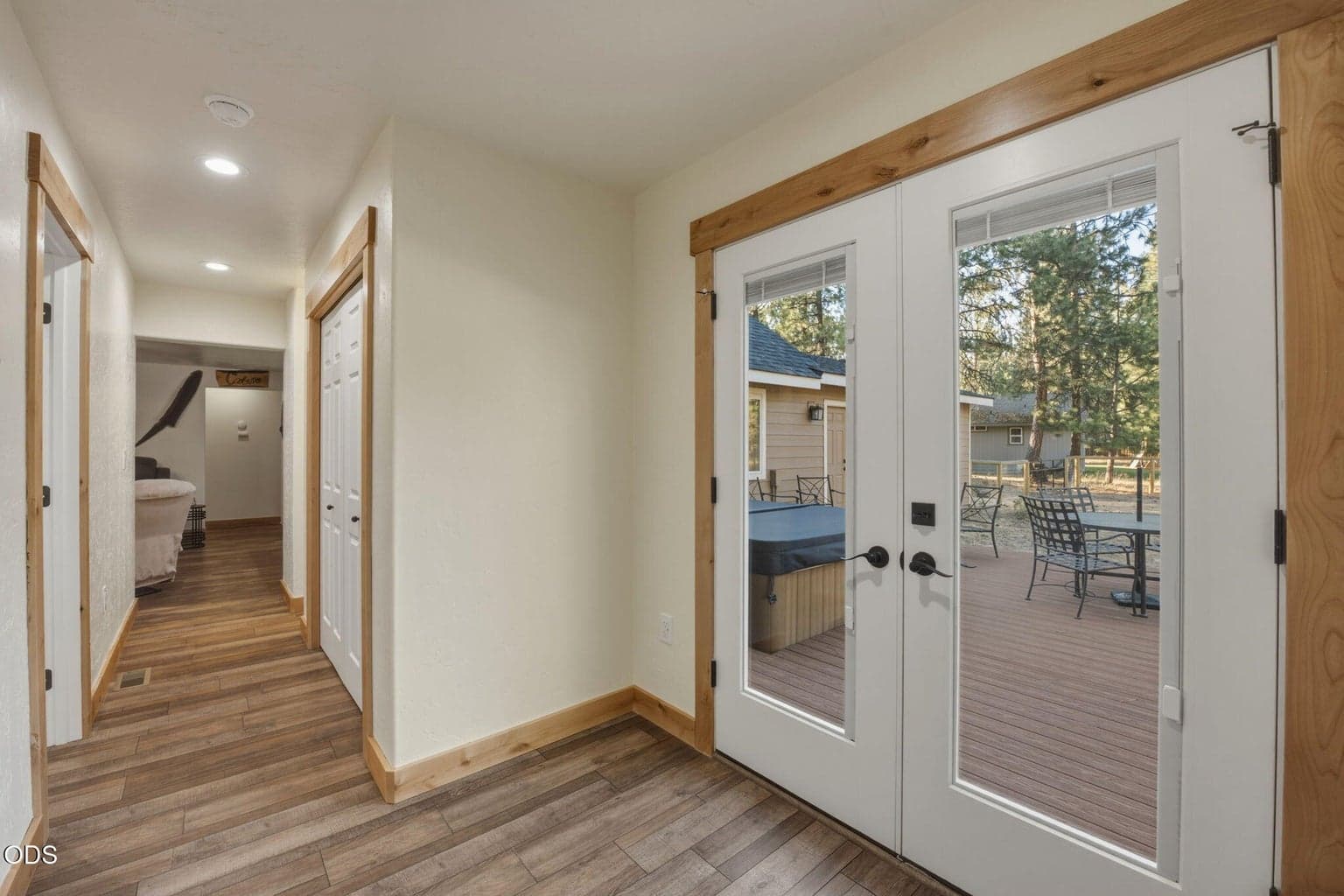 Hallway to primary suite with mudroom and access to the deck/hot tub