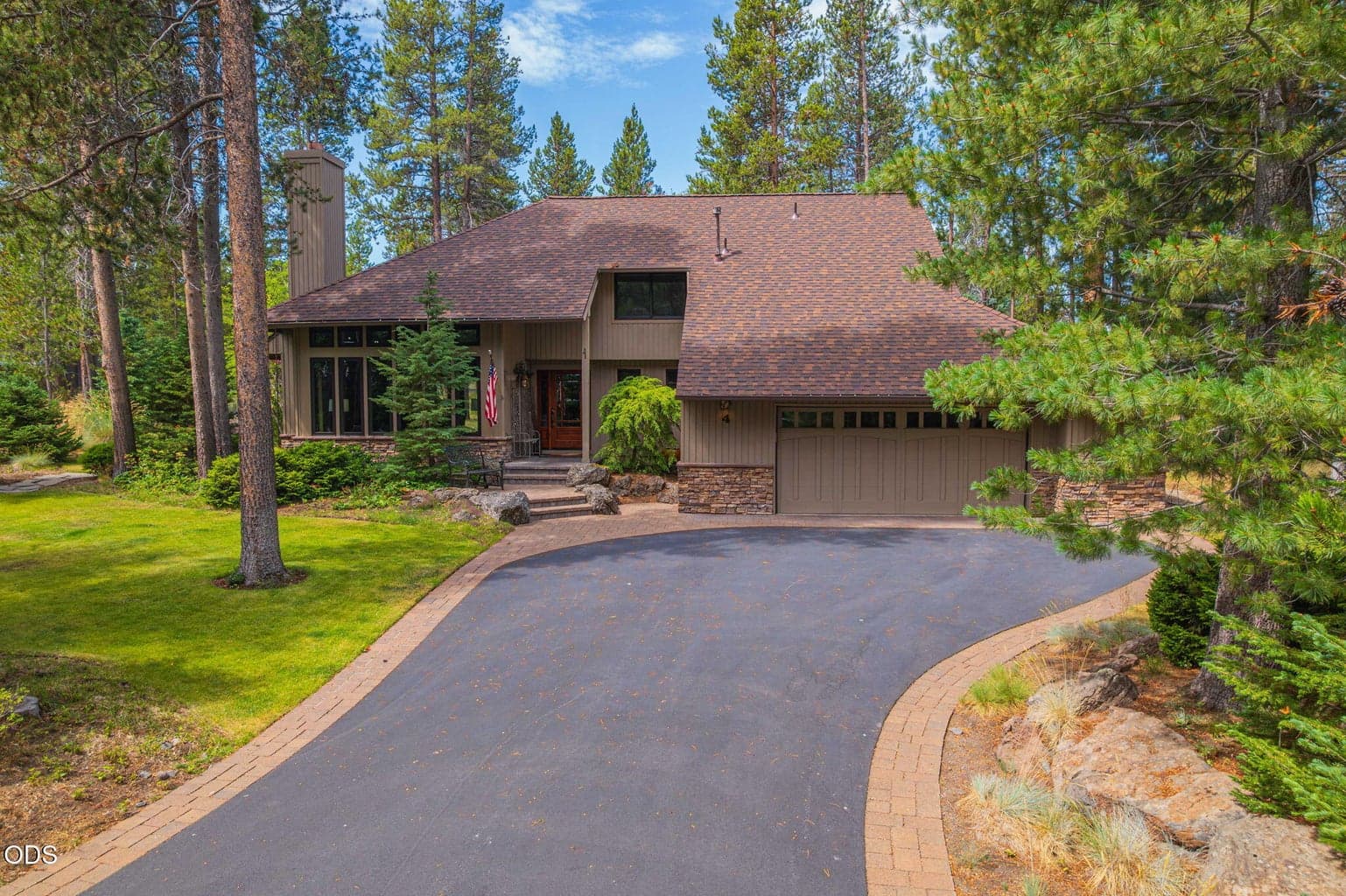 Surrounded by green lawn, mature trees and professionally landscaped yard.
