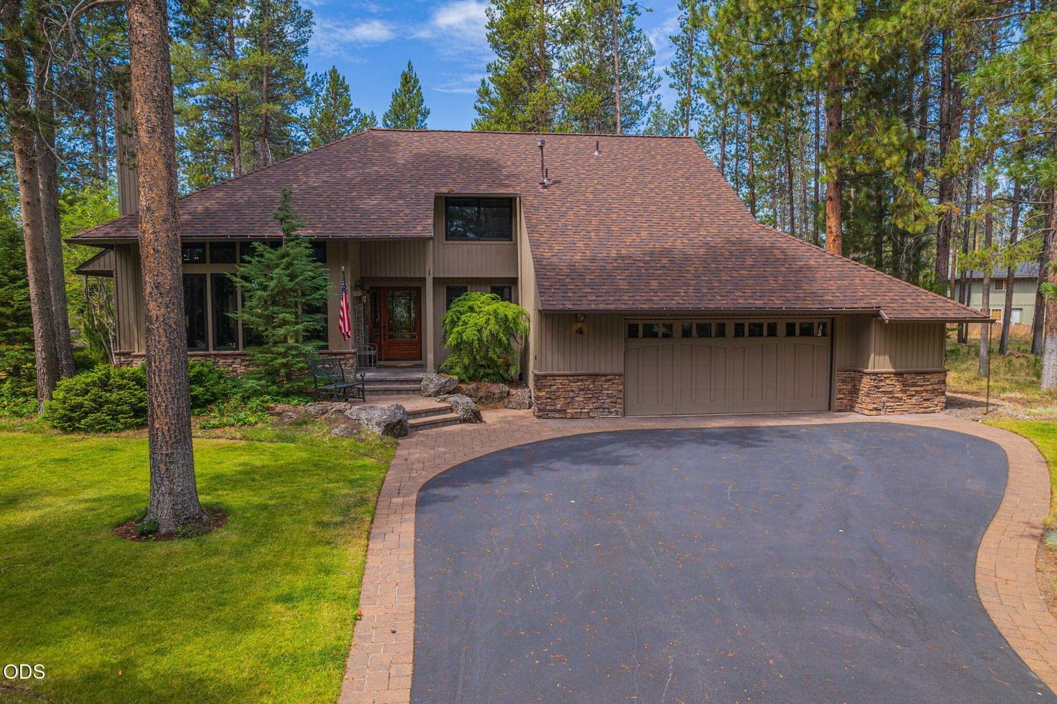 Stunning curb appeal with paver wrapped, asphalt driveway and a new roof.