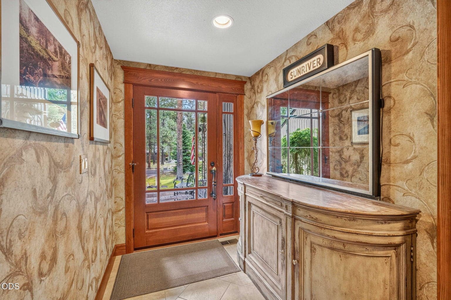 Step onto travertine tile flooring in this spacious entry way.