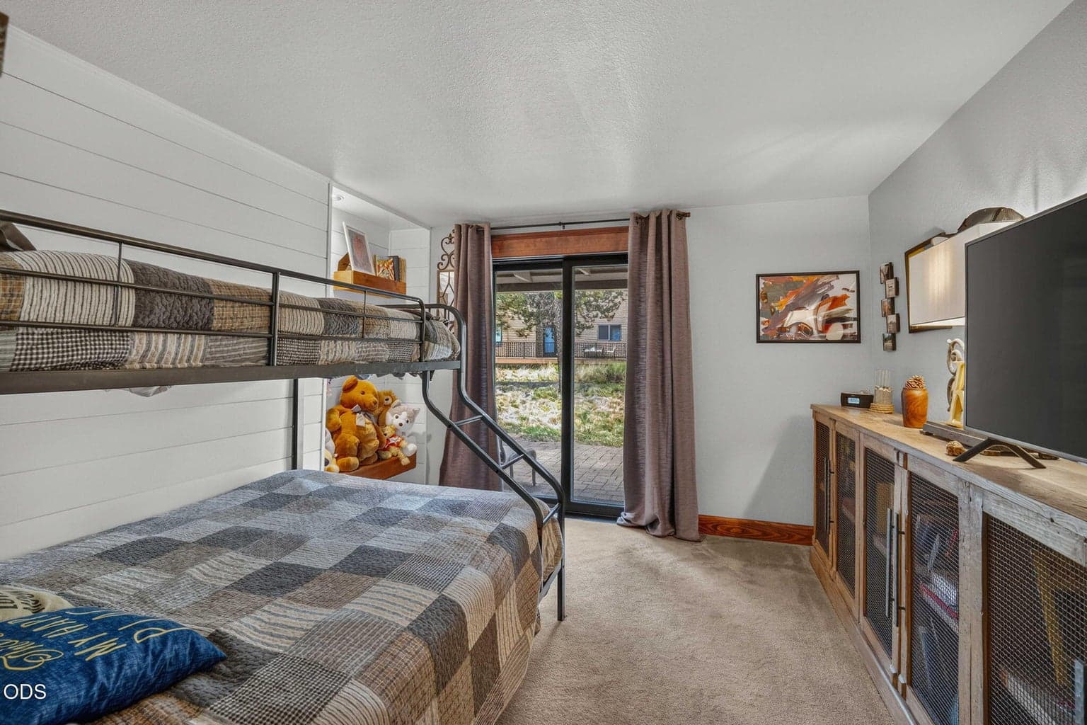 Bright guest room with slider that opens to rear patio; perfect retreat for guests or family stays.