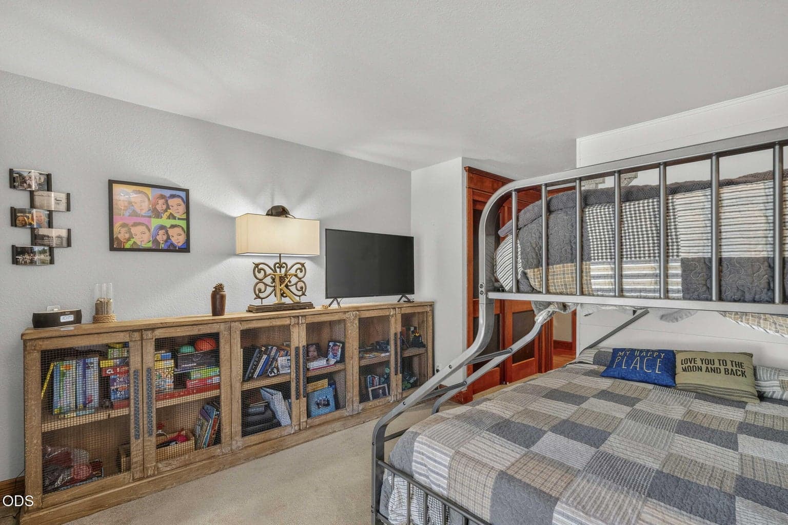 Featured here as a cozy bunk room with closet, TV console and playful modern, rustic charm - large enough to fit queen or possibly a king size bed.