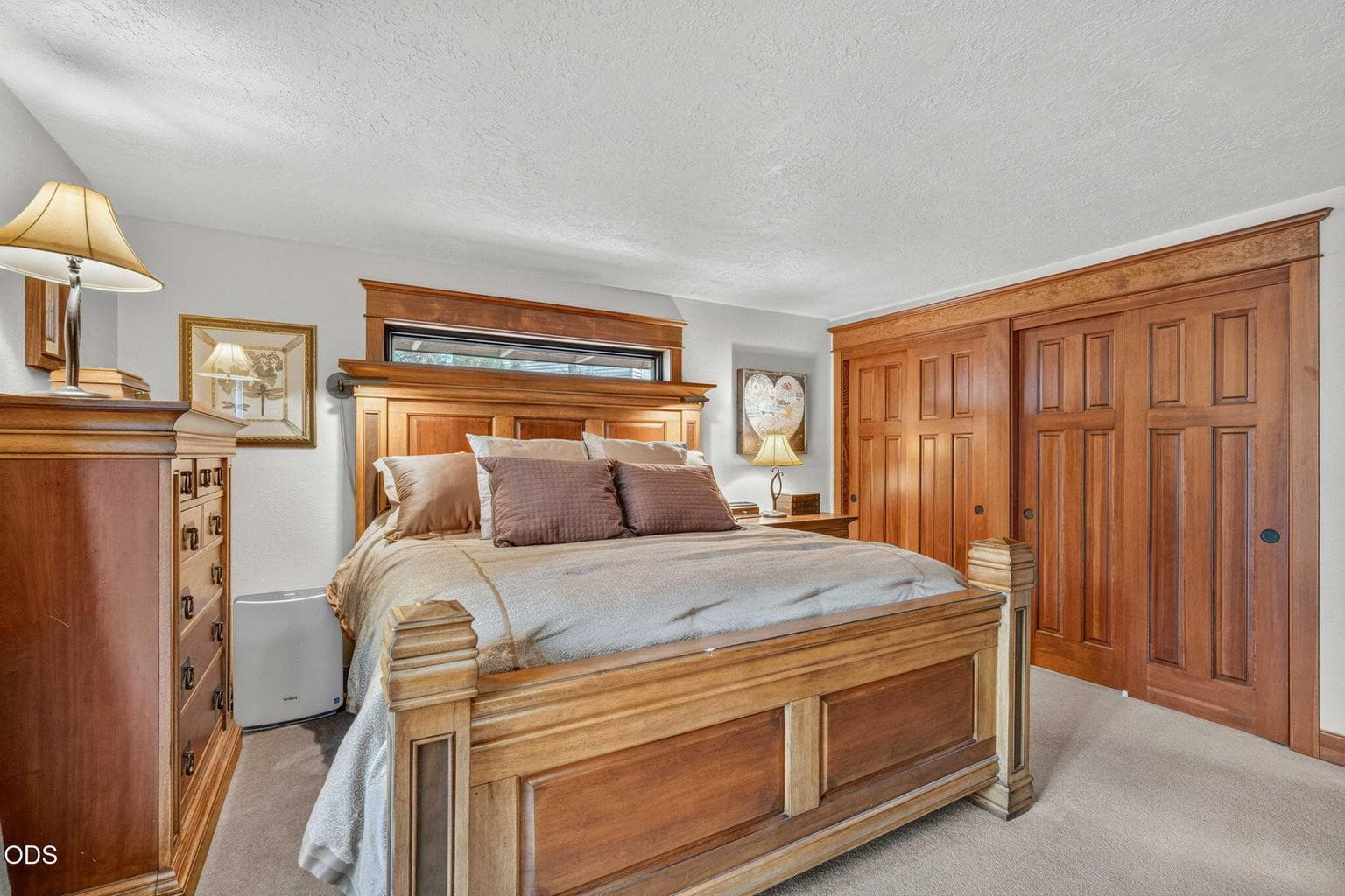 One of two primary bedrooms - rich wood trims, serene light and classic craftsman appeal to double closets that flank one wall.