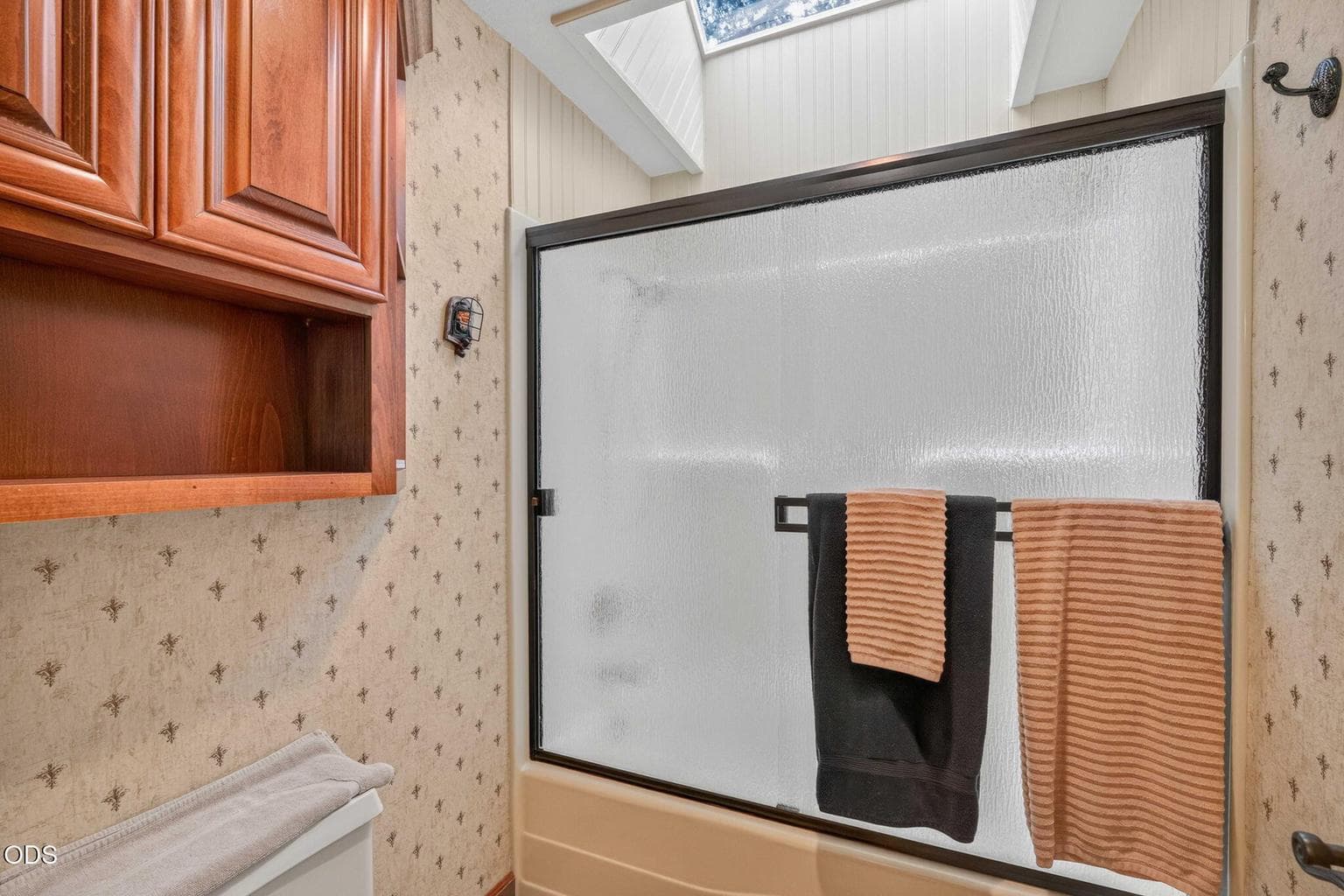 Ensuite bath with skylight, fiberglass shower/tub and rich cabinetry.