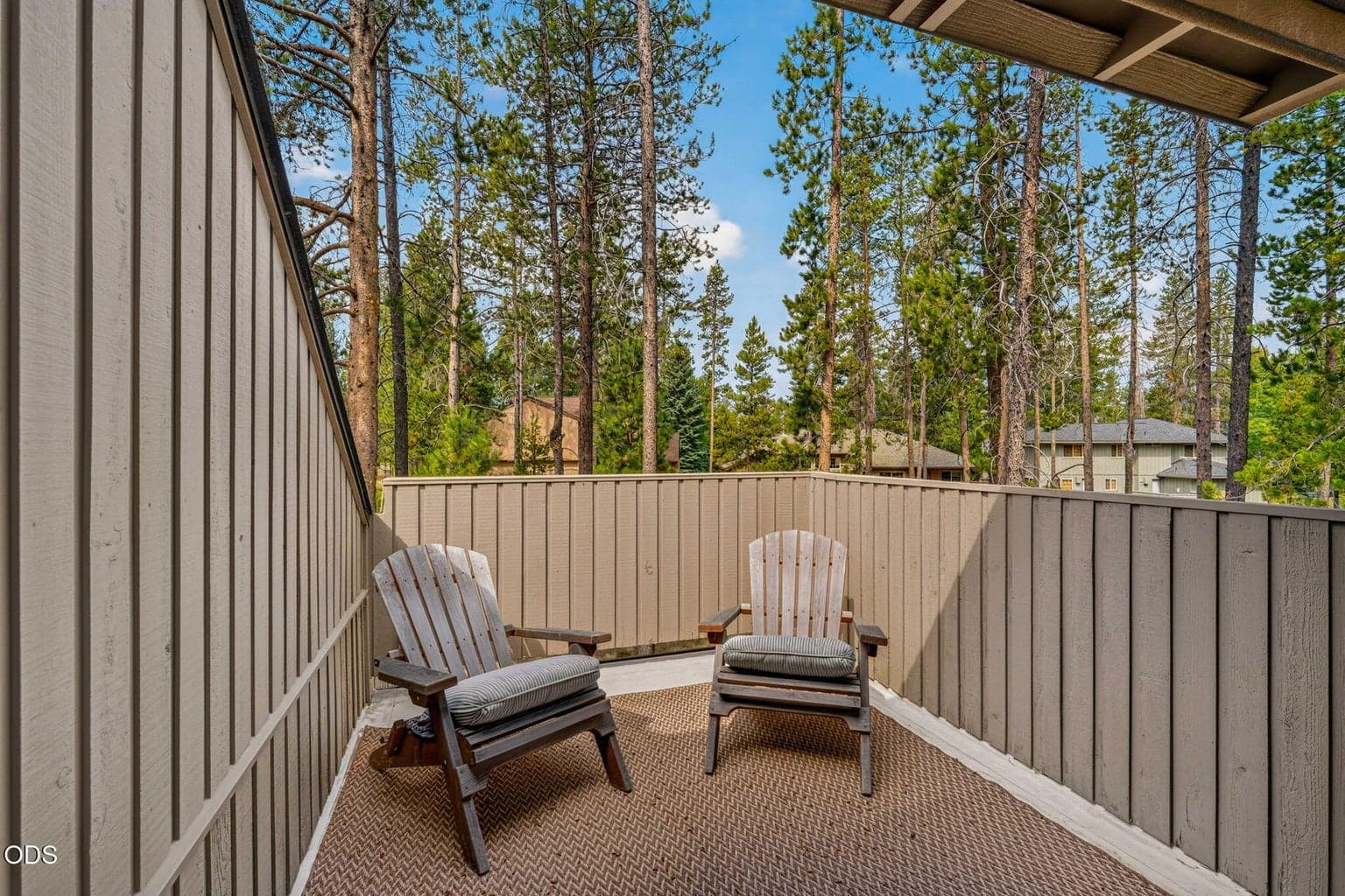 Secluded upper deck framed by pine treetops - an intimate retreat off the vaulted primary bath to be under the sun or the stars.